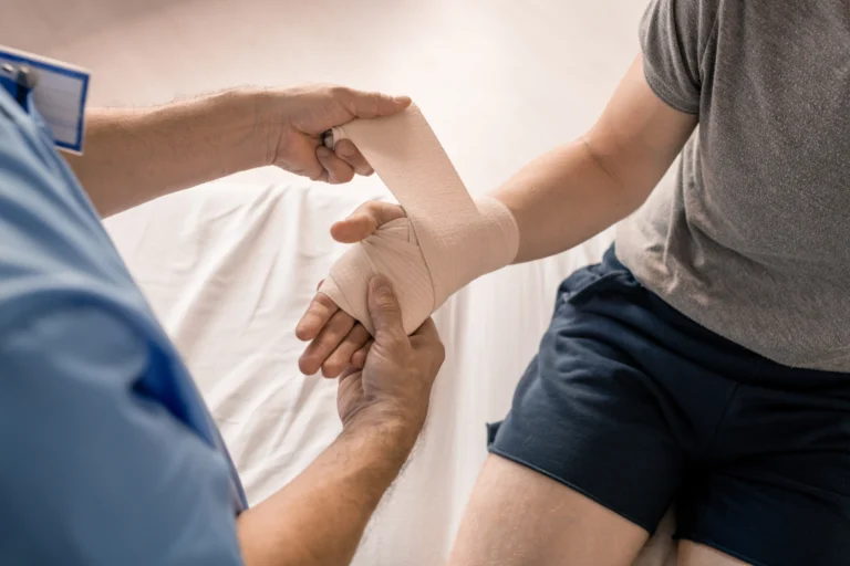 injured hand being wrapped with bandages